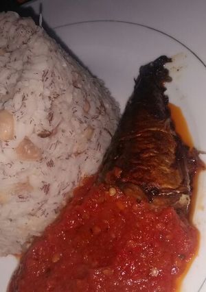 A picture of Rice and Beans with fish stew.