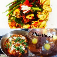 A picture of Shakshuka with warm garlic bread (poached eggs in spicy sauces).