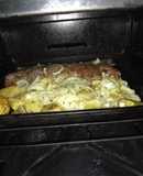 Peceto al horno con papas y cebollas