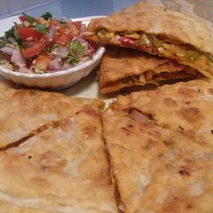 A picture of Chicken cheese paratha with (salsa) 🍕🧀🍅.
