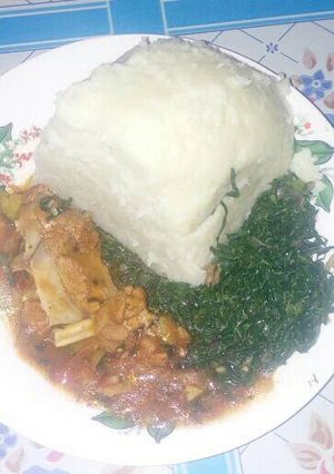 A picture of Ugali with fried sukamawiki and beef stew.