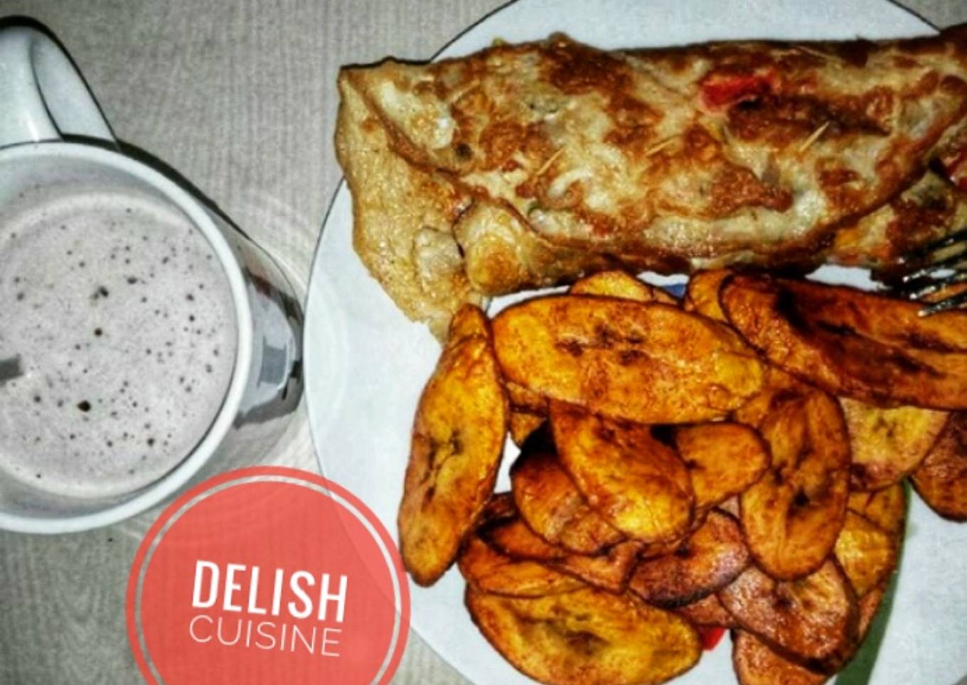 Fried plantain and eggs with a cup of hot tea