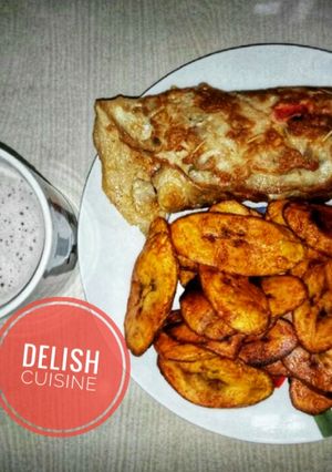 A picture of Fried plantain and eggs with a cup of hot tea.