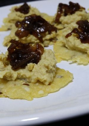 A picture of Crispy Parmesan Canapés with Hummus and Caramelized Onion Chutney.