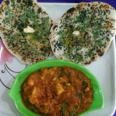 A picture of Stuff butter naan with aloo gravy.