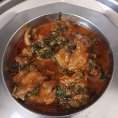 A picture of Methi chicken curry.