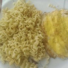 A picture of Indomie and fried egg for breakfast.
