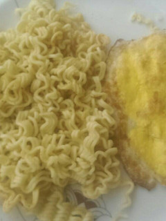 A picture of Indomie and fried egg for breakfast.