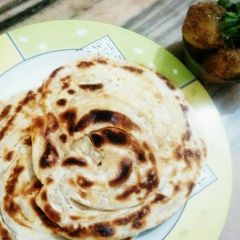 A picture of LACHHA PORATHA with CHOTA ALOO CURRY.