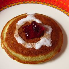 A picture of Blueberry pancakes with cream.