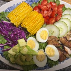 A picture of Chicken salad with honey mustard dressing / garlic bread.