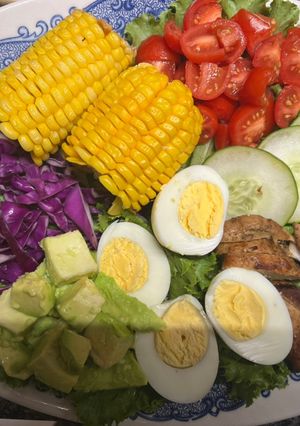 A picture of Chicken salad with honey mustard dressing / garlic bread.