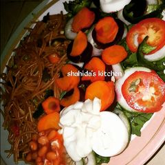 A picture of Fried spaghetti and salad.