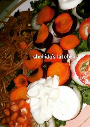 A picture of Fried spaghetti and salad.