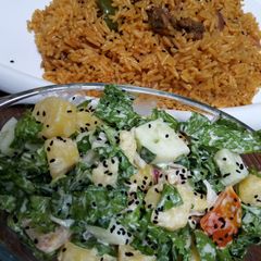 A picture of Jollof rice and salad.