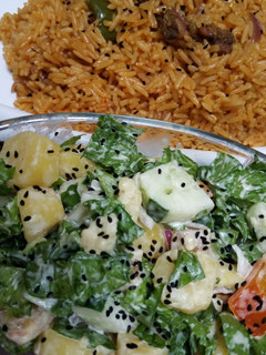 A picture of Jollof rice and salad.