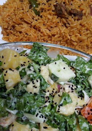 A picture of Jollof rice and salad.
