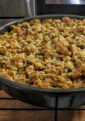 A picture of Pumpkin pie with pecan crumble topping.