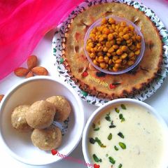 A picture of Khuba roth & spicy chickpea lentil & dry fruit kheer millet ladoo.