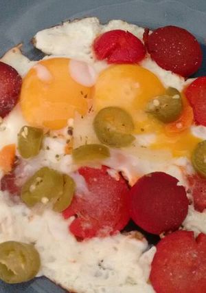 A picture of Fried Eggs with Chorizo and Pickled Peppers.