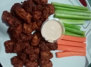 Una foto de Boneless con salsa de chapulines y aderezo rosa