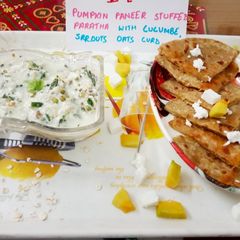 A picture of Pumpkin paneer stuff paratha with cucumber sprouts oats curd.