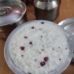 A picture of Curd rice with fruit anar.
