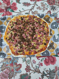 Una foto de Pizza salchichas, bacon y carne picada