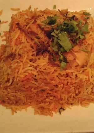 A picture of Flavoured Rice with Roasted Chicken.