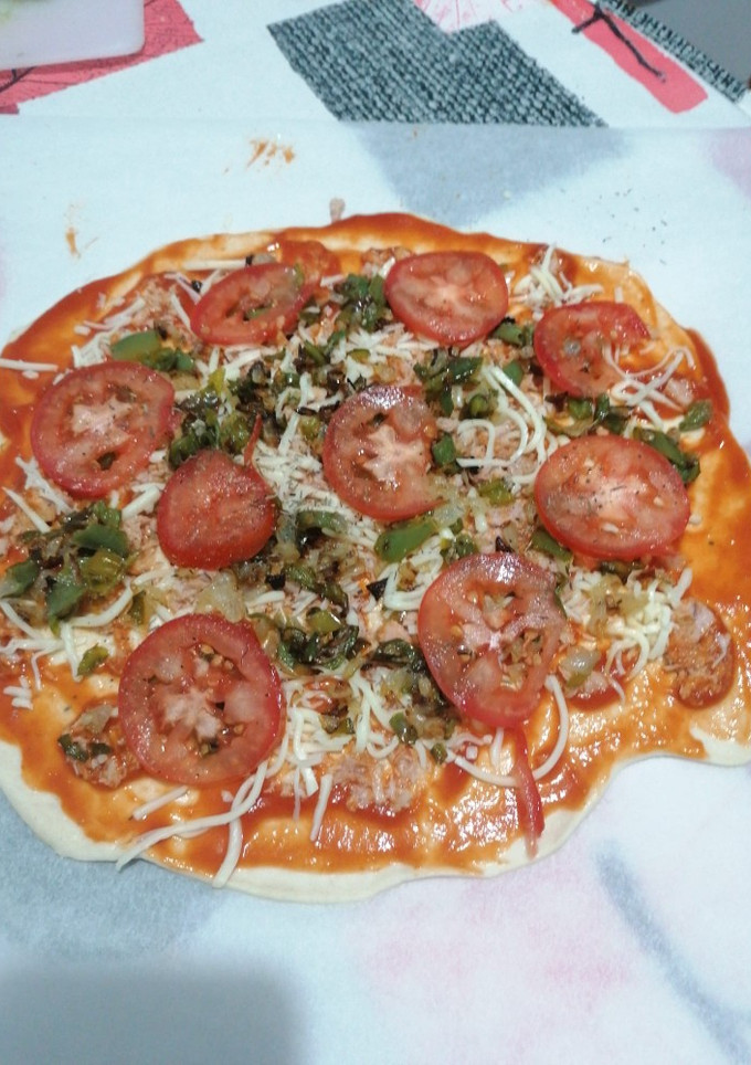 Una foto de Pizza de atún, cebolla, pimiento y tomate