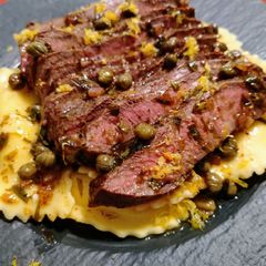 A picture of Flat iron steak with caper and tarragon brown butter.