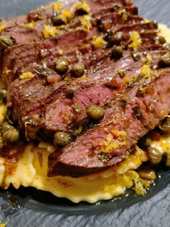 A picture of Flat iron steak with caper and tarragon brown butter.
