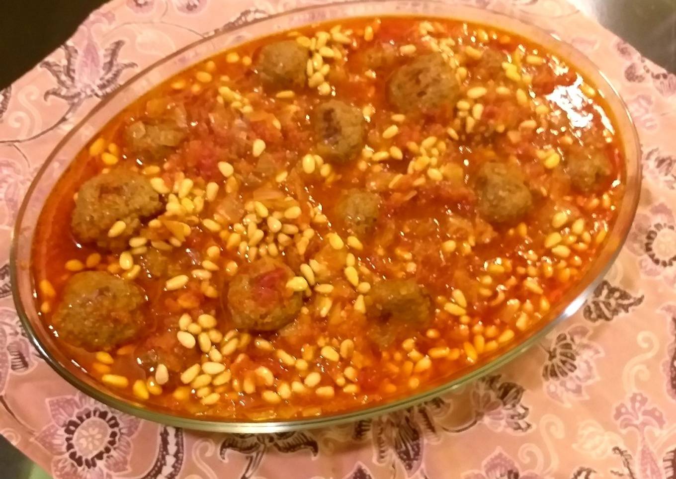 Meatballs and pine nuts in tomato sauce