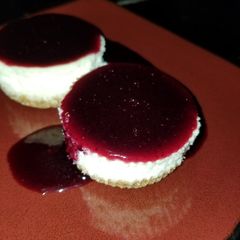 A picture of Mini Cheesecake with Blueberry Sauce.