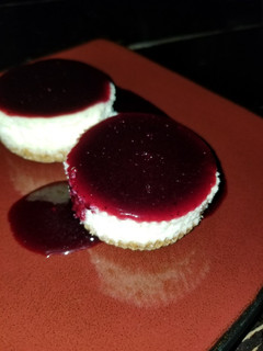 A picture of Mini Cheesecake with Blueberry Sauce.