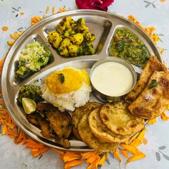 A picture of Navratri Bhog Thali with Basundi and Poori.