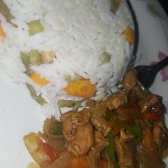 A picture of Vegetables rice and chicken stir fry.