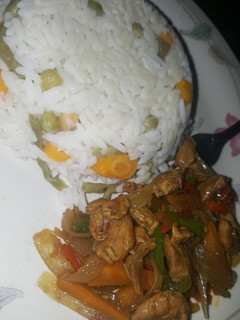 A picture of Vegetables rice and chicken stir fry.