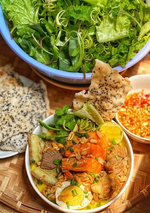 A picture of Mi Quang with Shrimp, Pork, Ribs, and Eggs.
