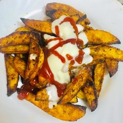 A picture of Seasoned baked potato wedges.
