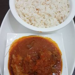 A picture of Beef stew and rice.
