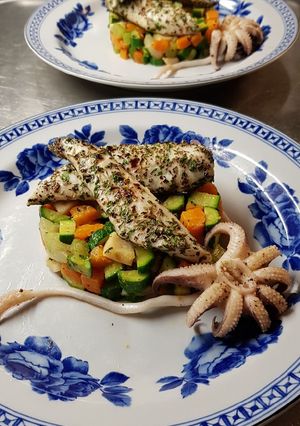 A picture of Branzino with Vegetable Caponata and Cuttlefish.