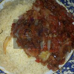 A picture of Cous cous with sauce.