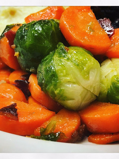 A picture of Garlicy Brussels Sprouts and Carrots with Crispy Bacon.