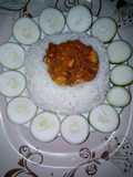 White rice and water snail stew, garnished with cucumber