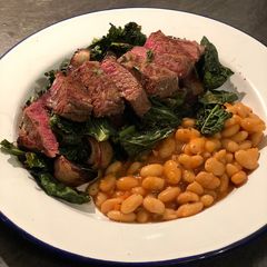 A picture of Venison with roast cavolo nero and beetroot. Stewed cannellini beans 🦌.
