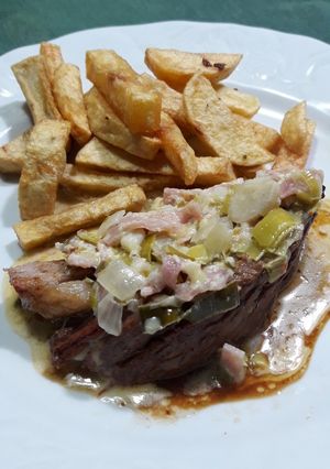 Una foto de Carne con crema de puerro, cebolla y jamón