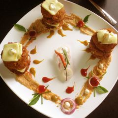 A picture of Rajma peanut tikki with creamy chickpea sauce.