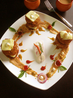 A picture of Rajma peanut tikki with creamy chickpea sauce.