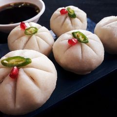 A picture of Steamed Rice ball stuffed with twisted pasta.